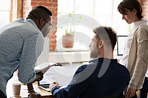 African American worker, trainee consulting with colleague