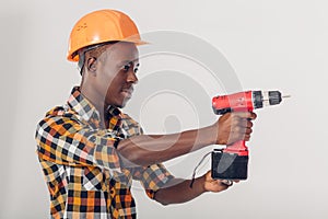 African American worker uses electric screwdriver