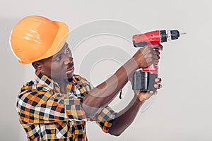 African American worker uses electric screwdriver