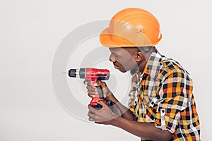 African American worker uses electric screwdriver