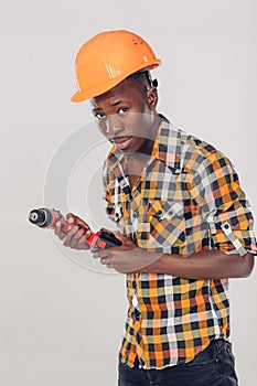 African American worker uses electric screwdriver