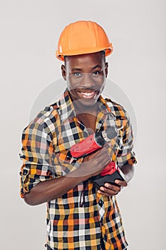 African American worker uses electric screwdriver