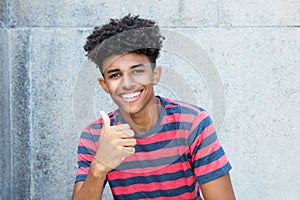 African american young adult man showing thumb up