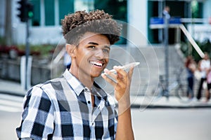 African american young adult using voice recognition at phone