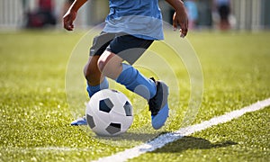 African American young boy playing soccer in a stadium pitch