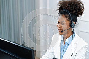 African American young businesswoman wearing headset working in crucial office