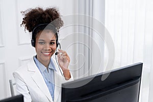 African American young businesswoman wearing headset working in crucial office