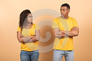 African american young couple standing separate and crossing hands, don't talk to each other after family quarrel