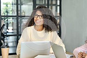 African american young female student sitting using laptop at modern office.