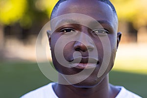 African American young male athlete standing on a field, looking directly at camera, copy space photo