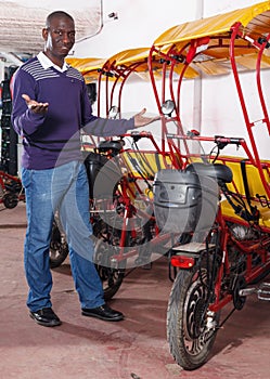 African-American young man offering cycle rickshaw service