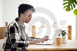 African american young woman using laptop working or studying online