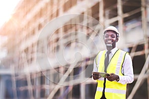 African architects engineer man with tablet work together in the inside the construction building site.Engineering concepts and