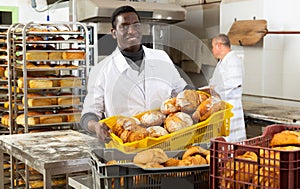 African baker carrying bread in box