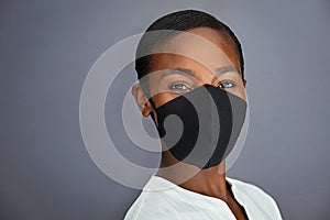 African beautiful woman wearing face mask on grey background
