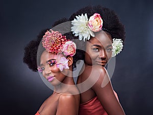 African, beauty and friends with flowers in makeup and art in dark background, studio and mockup. Floral, cosmetics and
