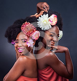 African, beauty and friends with flowers in makeup and art on dark background, studio and mockup. Floral, cosmetics and