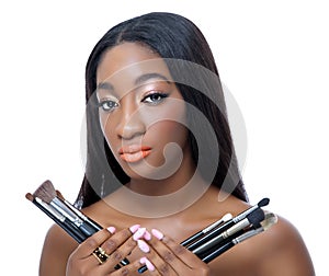 African beauty holding make up brushes