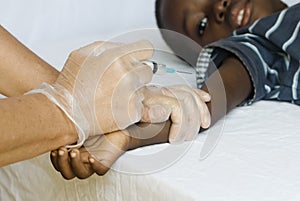 African black boy getting a vaccination from a white medical doctor