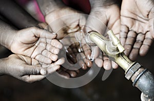 African Black Children with Hands Cupped under Clean Hygienic Wa