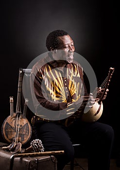 African black man with ethnic musical instrument