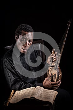 African black man with ethnic musical instrument