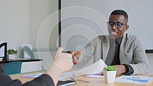 African black man shake hands with his business partner caucasian woman