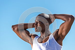 African black man wearing white vest and blue short jeans