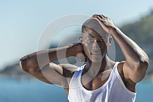 African black man wearing white vest and blue short jeans