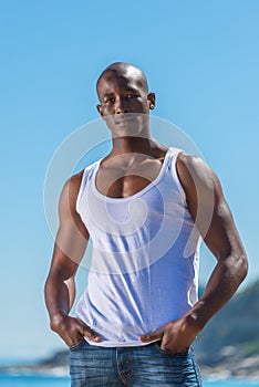 African black man wearing white vest and blue short jeans