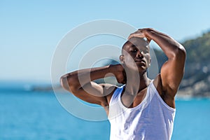 African black man wearing white vest and blue short jeans