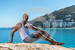 African black man wearing white vest and blue short jeans