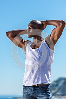 African black man wearing white vest and blue short jeans