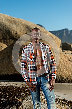 African black model with six pack in unbuttoned checkered shirt