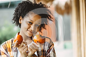 African black teen girl portrait with tomato healthy vetetable food for high vitamin