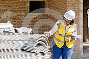 African black women worker work in construction site for site inspector job checking project progress