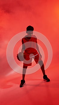 African boy basketball player dribbling with ball