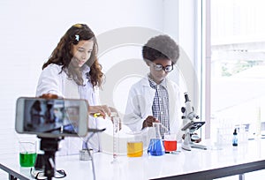 African boy and caucasian girl streaming video clip of online studying