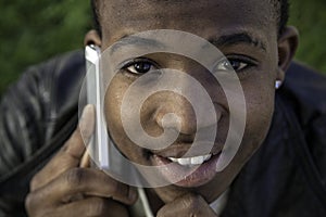 African boy on cell phone outside