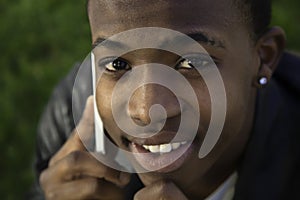 African boy on cell phone outside