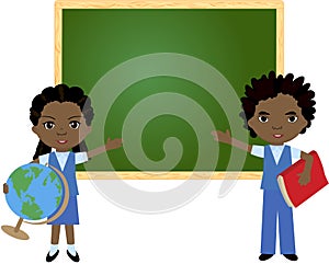 African boy and girl standing near the blackboard in a classroom