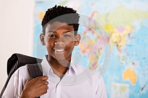 African boy in his school uniform and backpack