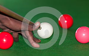 An African boy playing snooker