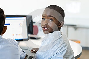 African boy using computer at school