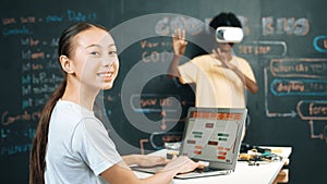 African boy using VR glasses while young woman looking at camera. Edification.