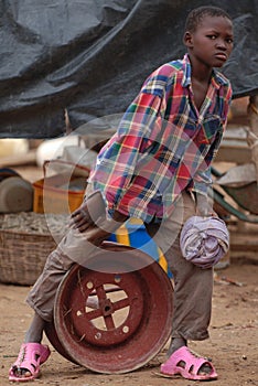 African boy on wheel rim