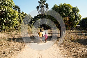 African Brothers Walking Outdoors in a Tribal Village