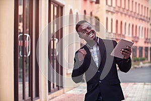 African Business man celebrating success with keeping arms raised and expressing positivity action