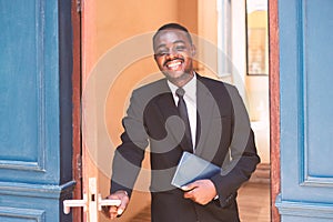 African business man opened the door with smile and be friendly