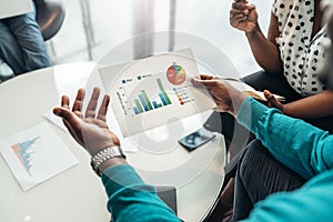 African business man sharing information and statistics from a graph during a meeting